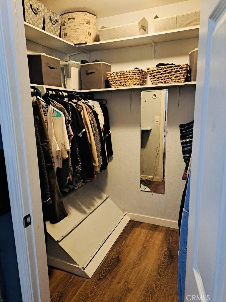 7304 Exeter Street, Unit E Paramount, CA 90723 - Photo 19 of 36 Spacious walk-in closet in the primary bedroom featuring a deep, wide layout with abundant shelving for additional storage.