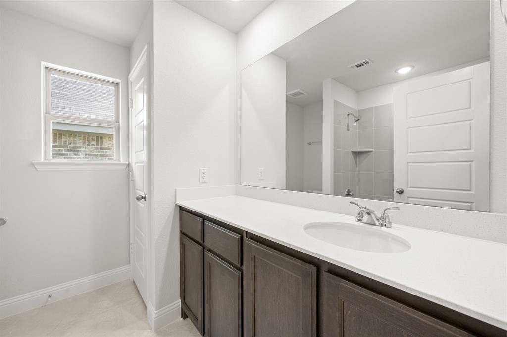 228 Shepards Street Godley, TX 76044 - Photo 22 of 27 a bathroom with a sink double vanity and a mirror