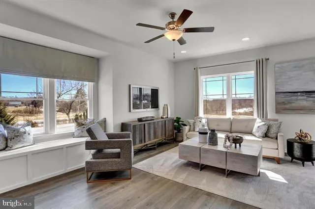 a living room with furniture and a large window