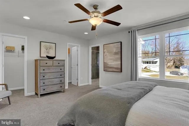 a bedroom with a bed and a ceiling fan