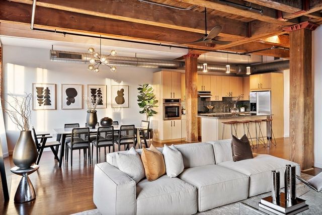 a living room with furniture wooden floor and dining table
