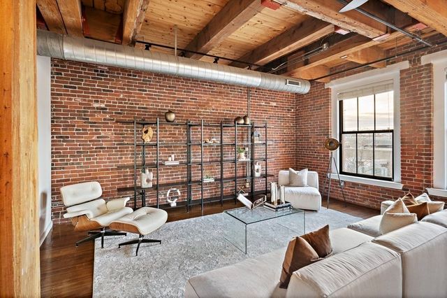 a living room with furniture windows and a table