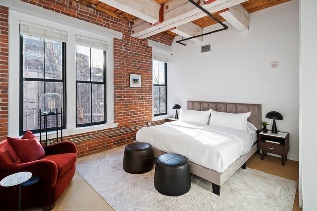 a spacious bedroom with a bed and a couch