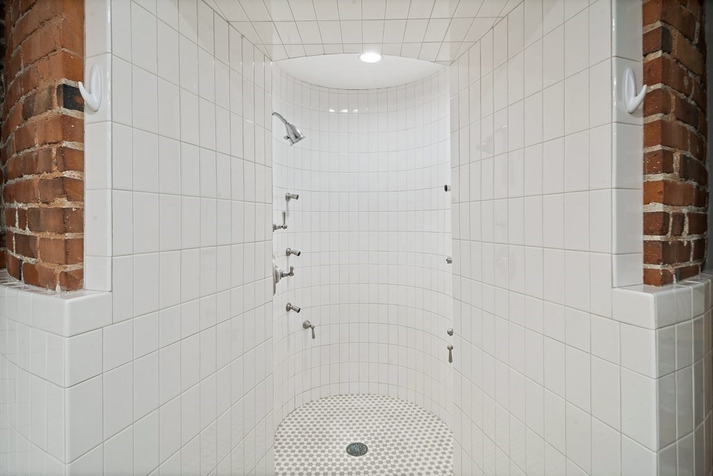 9 West Broadway, Unit 312 Boston, MA 02127 - Photo 17 of 35 a bathroom with a bathtub and shower