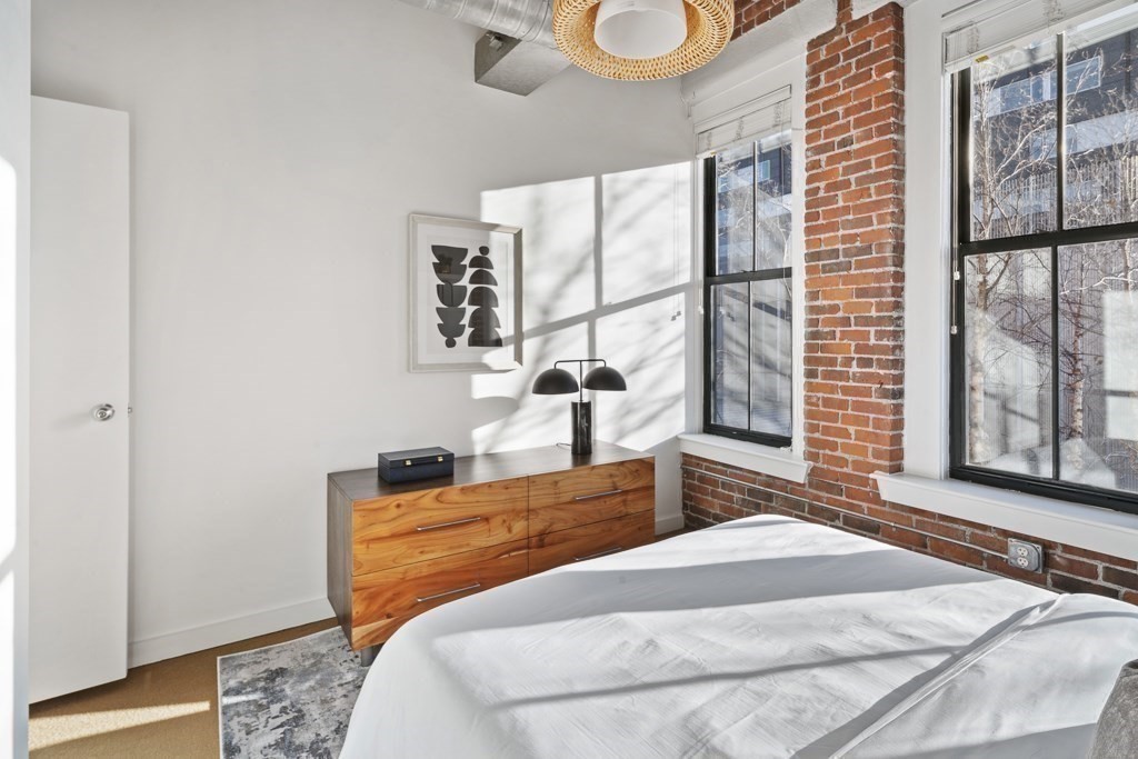 9 West Broadway, Unit 312 Boston, MA 02127 - Photo 19 of 35 a bedroom with a bed and a large window