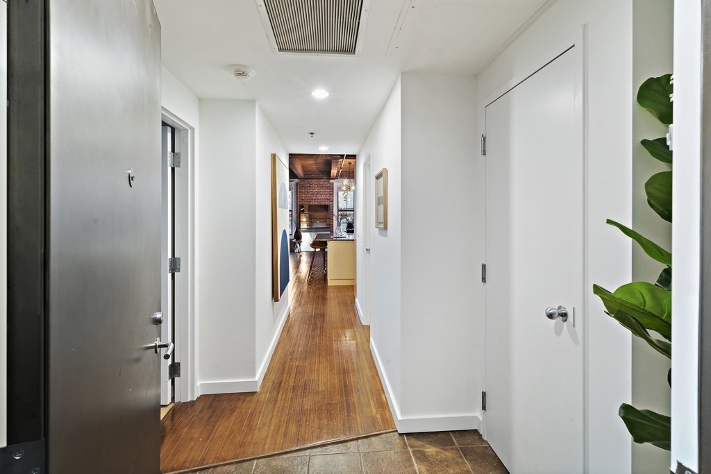 9 West Broadway, Unit 312 Boston, MA 02127 - Photo 22 of 35 wooden floor with closet