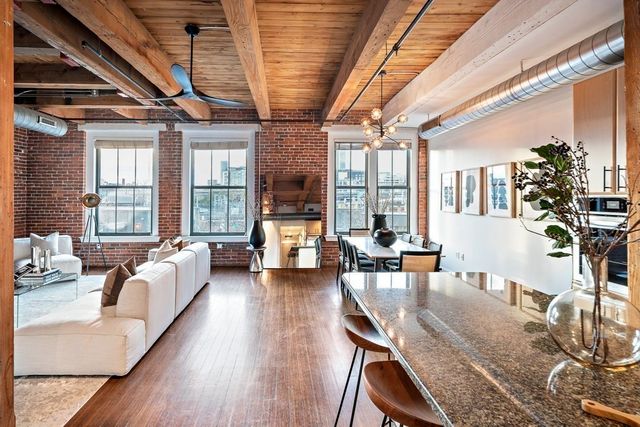a living room with furniture a large window with wooden floor