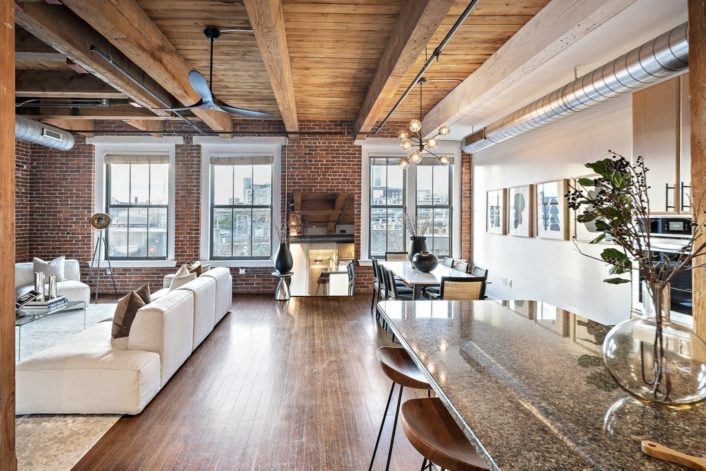 9 West Broadway, Unit 312 Boston, MA 02127 - Photo 3 of 35 a living room with furniture a large window with wooden floor