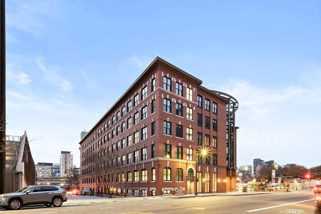a view of a tall building next to a road