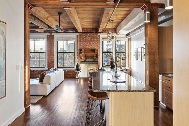 a very nice looking room with a large window and wooden floor