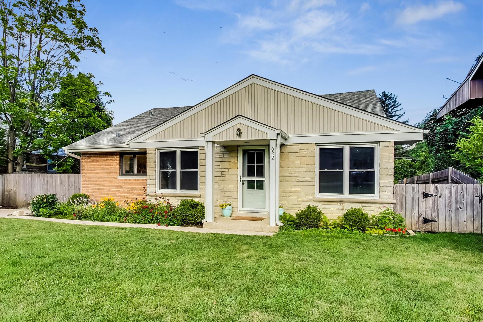a view of a house with garden and yard