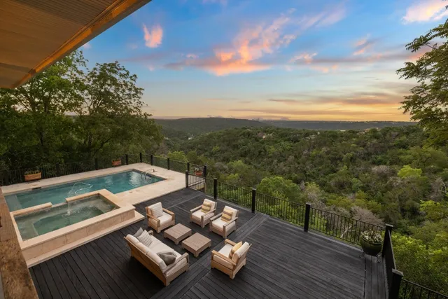 a view of a balcony with wooden floor and lake view
