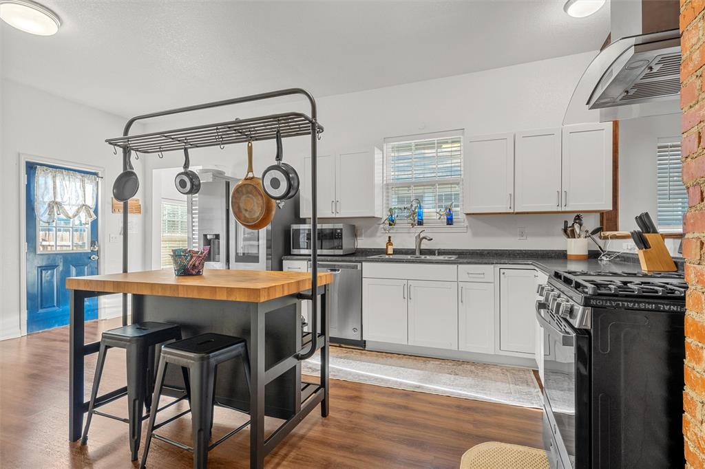 1200 North 15th Street Waco, TX 76707 - Photo 8 of 19 a kitchen with a table chairs sink and cabinets