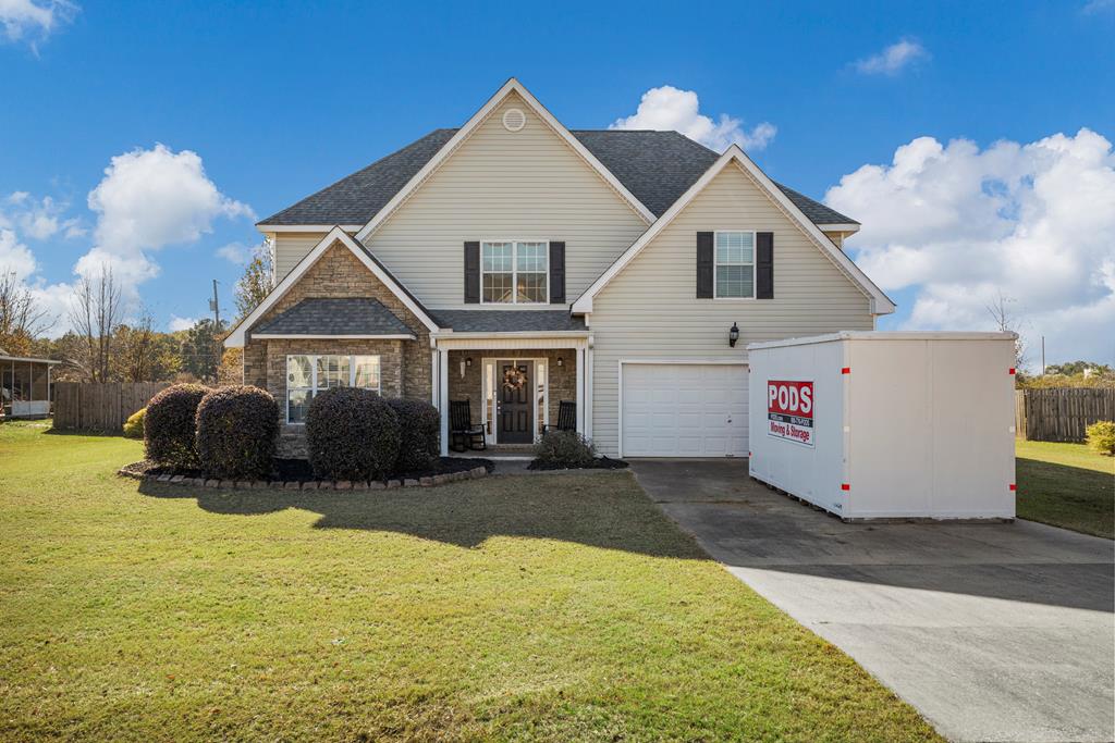 a front view of a house with a yard