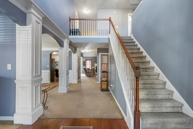 a view of entryway and hall with wooden floor