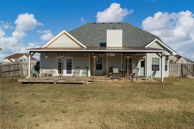 a front view of a house with swimming pool and sitting area