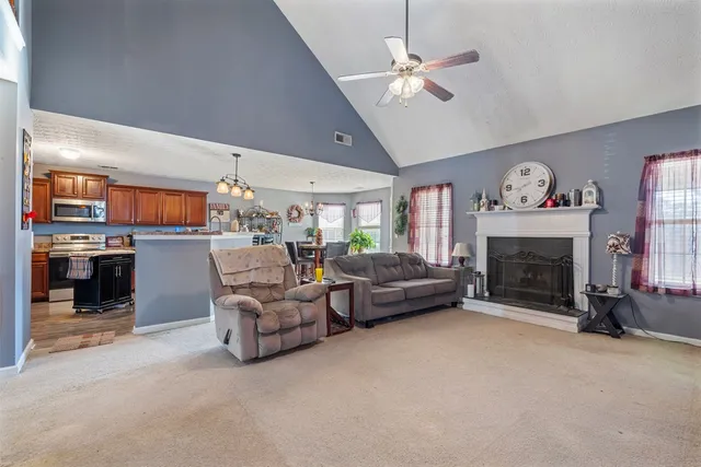 a living room with furniture and a fireplace