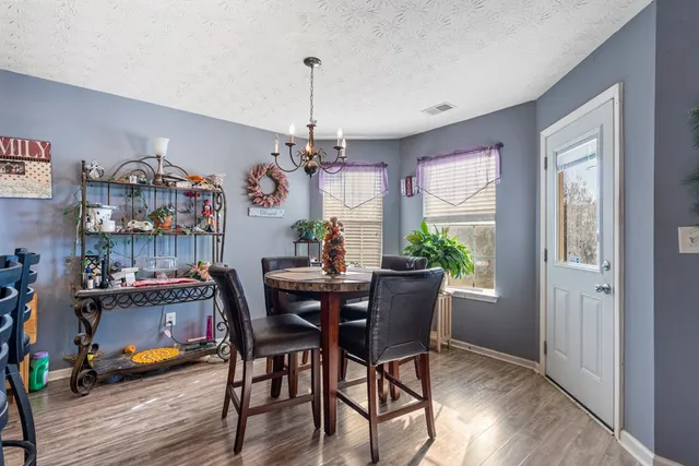 a view of a dining room with furniture window and wooden floor