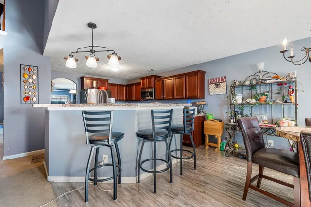 a view of a dining room with furniture and chandelier