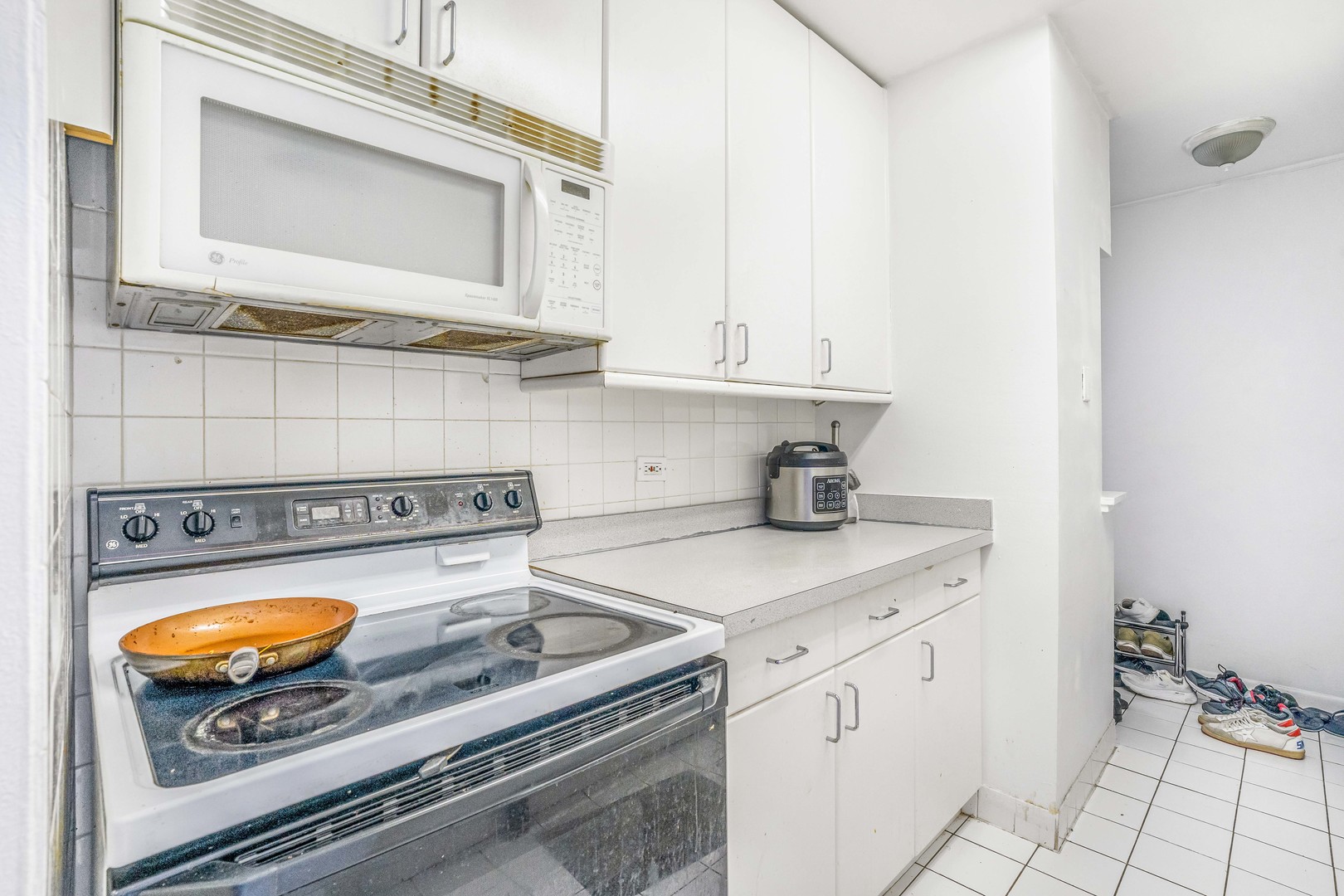 6171 North Sheridan Road, Unit 2804 Chicago, IL 60660 - Photo 4 of 27 a kitchen with a stove and a microwave