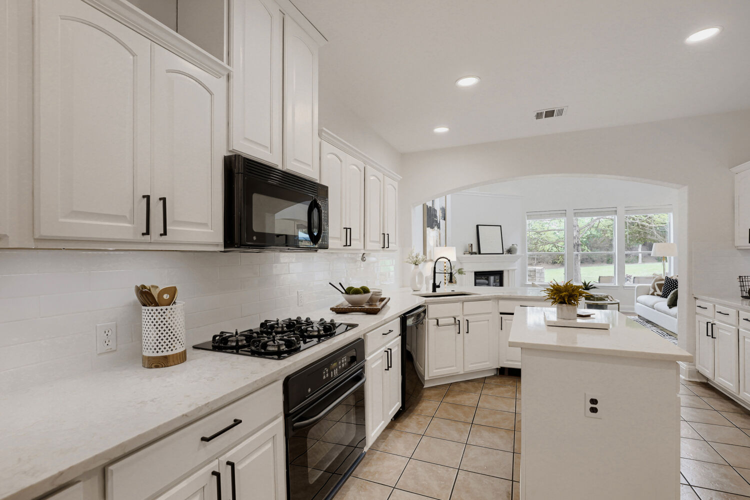 112 Aria Ridge Austin, TX 78738 - Photo 11 of 30 a kitchen with white cabinets a sink dishwasher and a stove with wooden floor
