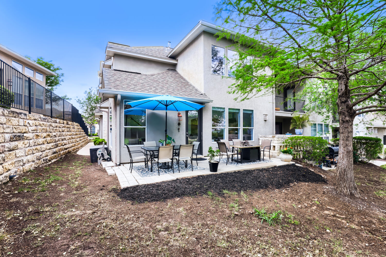 112 Aria Ridge Austin, TX 78738 - Photo 22 of 30 a view of a house with backyard porch and sitting area