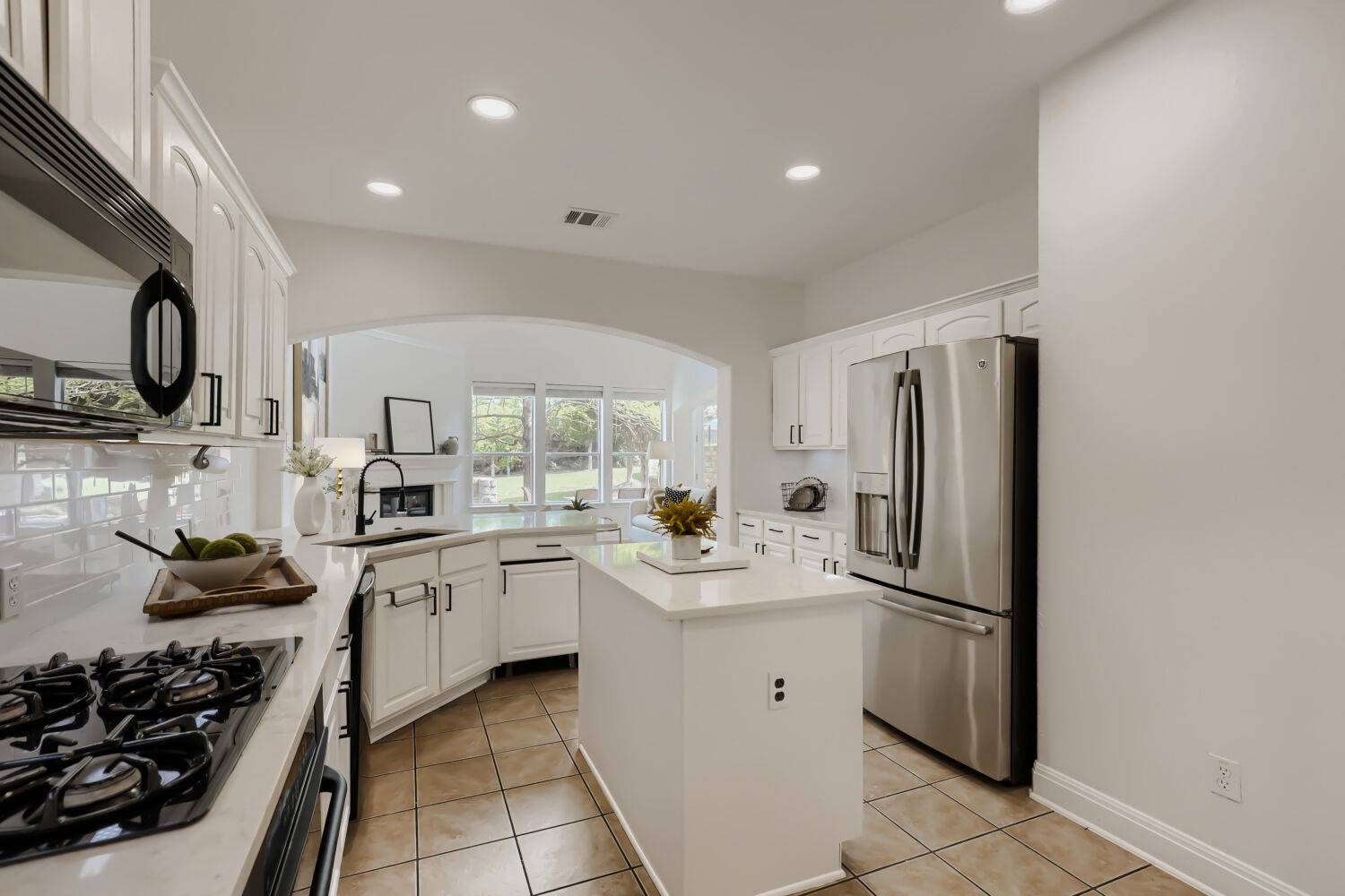 112 Aria Ridge Austin, TX 78738 - Photo 10 of 30 a kitchen with stainless steel appliances a sink a stove a refrigerator and white cabinets