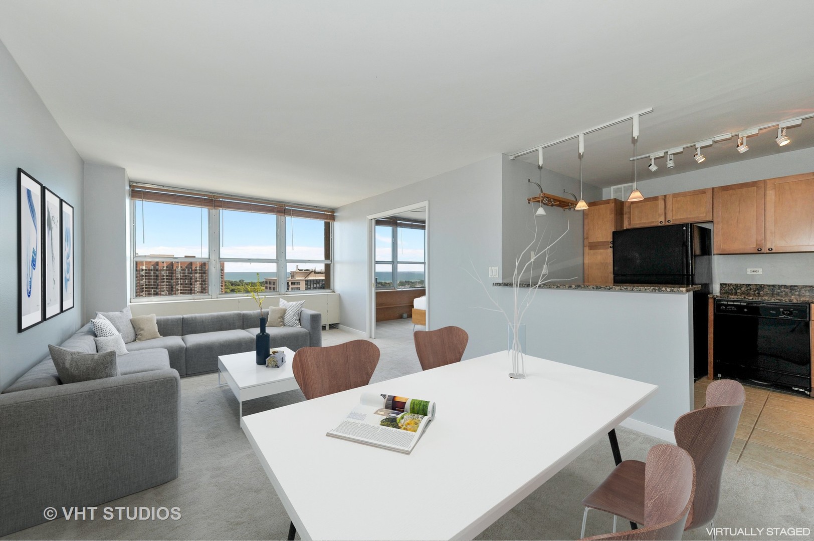 655 West Irving Park Road, Unit 2106 Chicago, IL 60613 - Photo 4 of 15 a living room with couches a coffee table and kitchen view with wooden floor