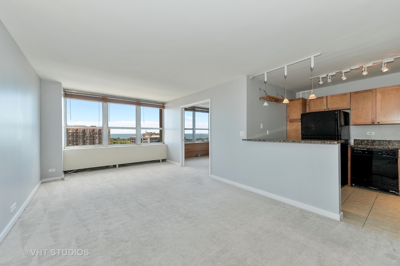 655 West Irving Park Road, Unit 2106 Chicago, IL 60613 - Photo 8 of 15 a view of an empty room with a kitchen