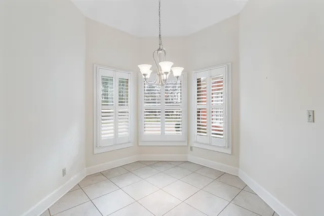 an empty room with windows and entrance