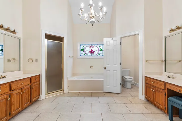 a spacious bathroom with a tub sink and a mirror