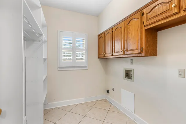 a view of an empty room with window and cabinet