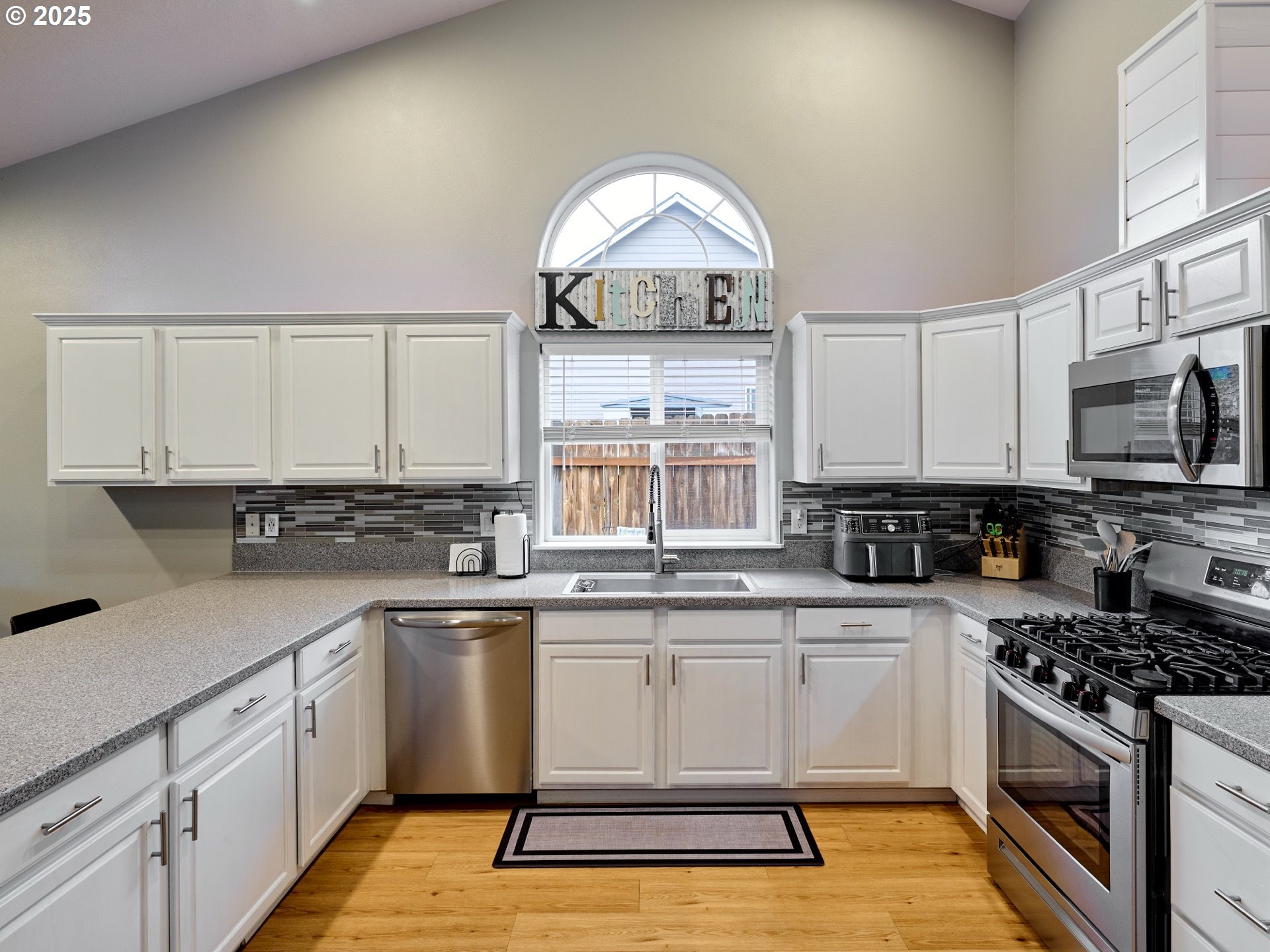 1353 Jodi Drive Silverton, OR 97381 - Photo 17 of 48 a kitchen with a sink white cabinets and stainless steel appliances