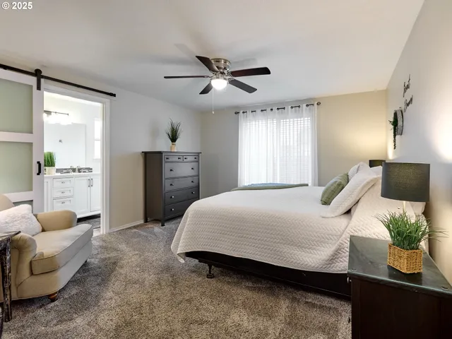 a bedroom with a bed couch and window