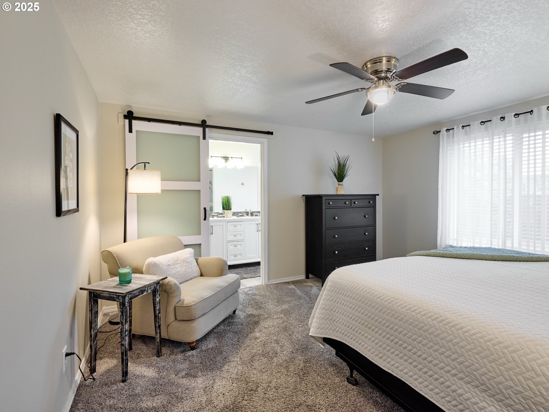 1353 Jodi Drive Silverton, OR 97381 - Photo 21 of 48 a spacious bedroom with a bed a couch and a window