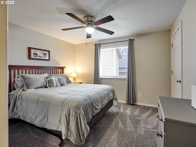 a bedroom with a large bed and a window