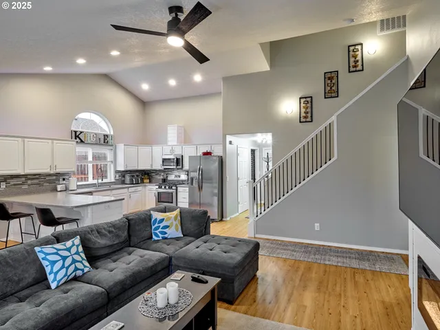 a living room with furniture and kitchen view