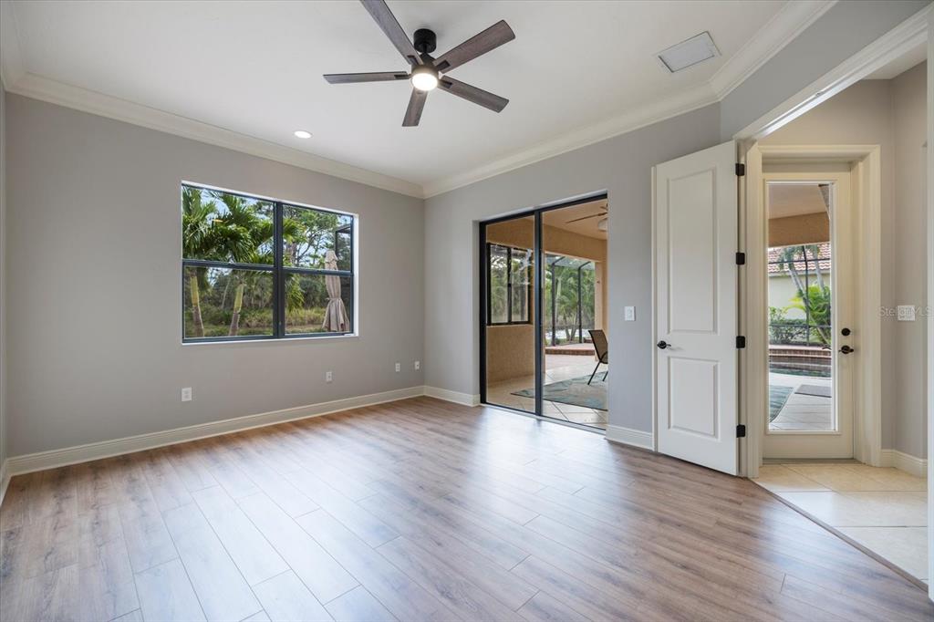 616 Crane Prairie Way Osprey, FL 34229 - Photo 17 of 54 wooden floor in an empty room with a window