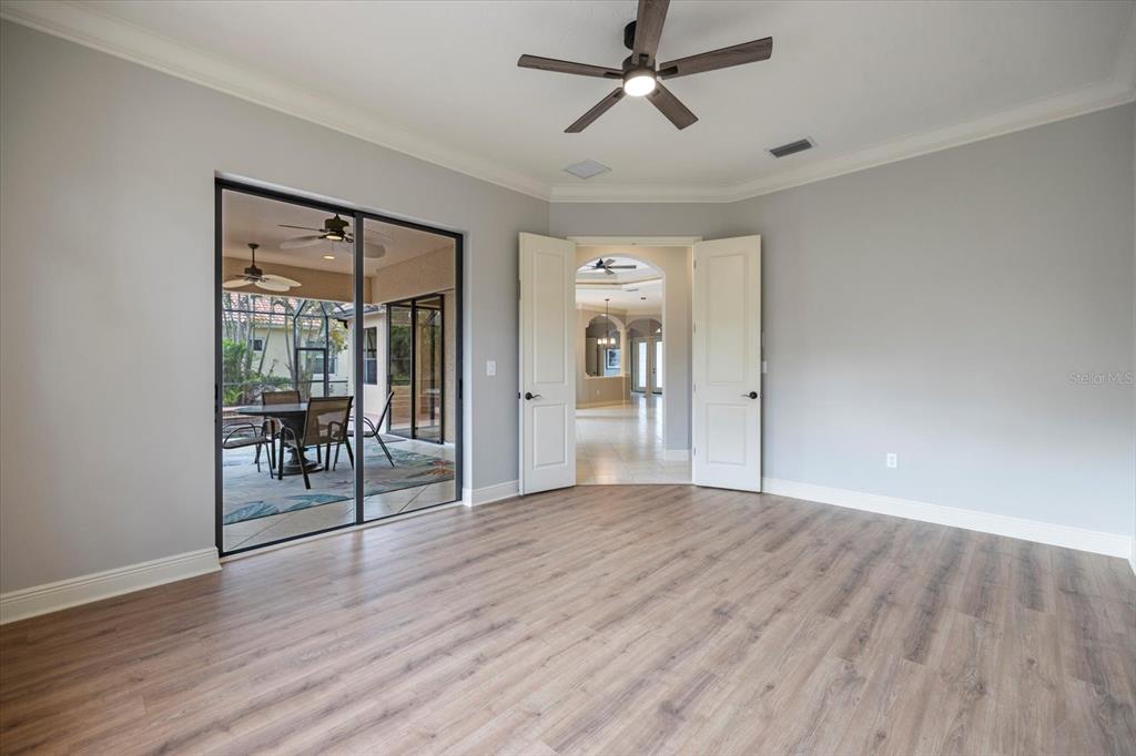 616 Crane Prairie Way Osprey, FL 34229 - Photo 18 of 54 a view of a livingroom with wooden floor and a ceiling fan