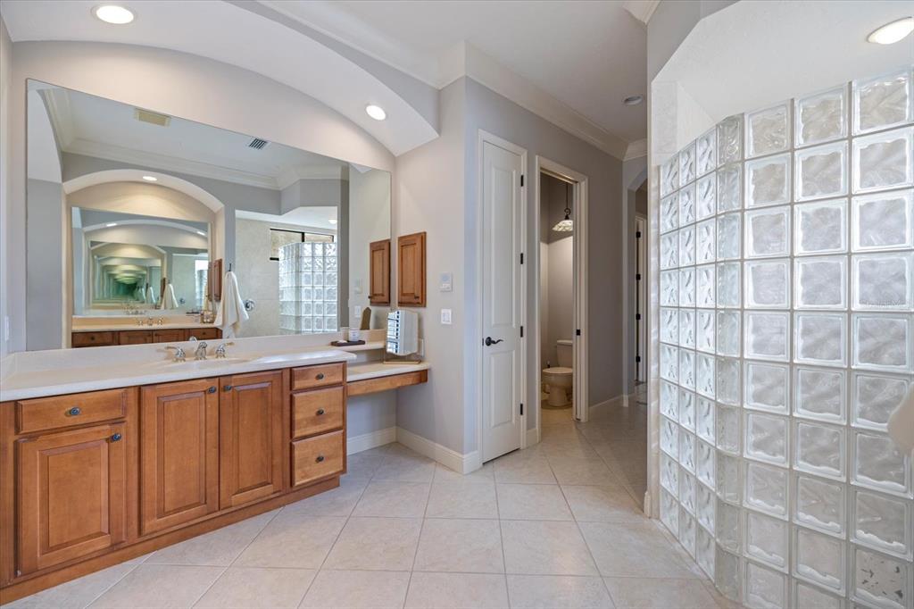 616 Crane Prairie Way Osprey, FL 34229 - Photo 25 of 54 a large bathroom with a large mirror vanity and shower