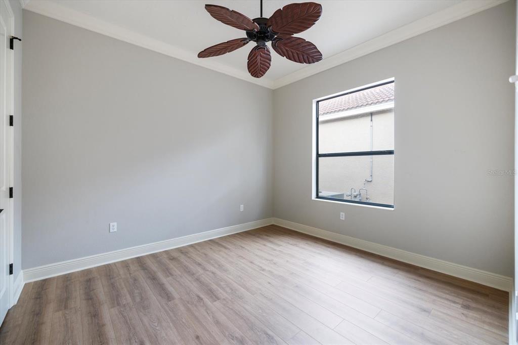 616 Crane Prairie Way Osprey, FL 34229 - Photo 27 of 54 wooden floor in an empty room with a window