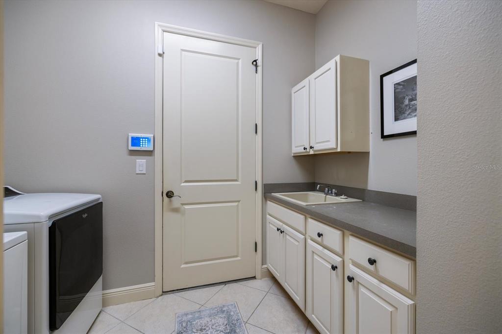 616 Crane Prairie Way Osprey, FL 34229 - Photo 50 of 54 a kitchen with cabinets appliances and a sink