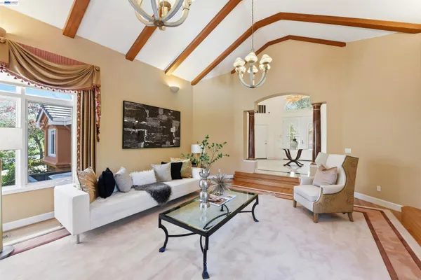 a living room with furniture and a floor to ceiling window