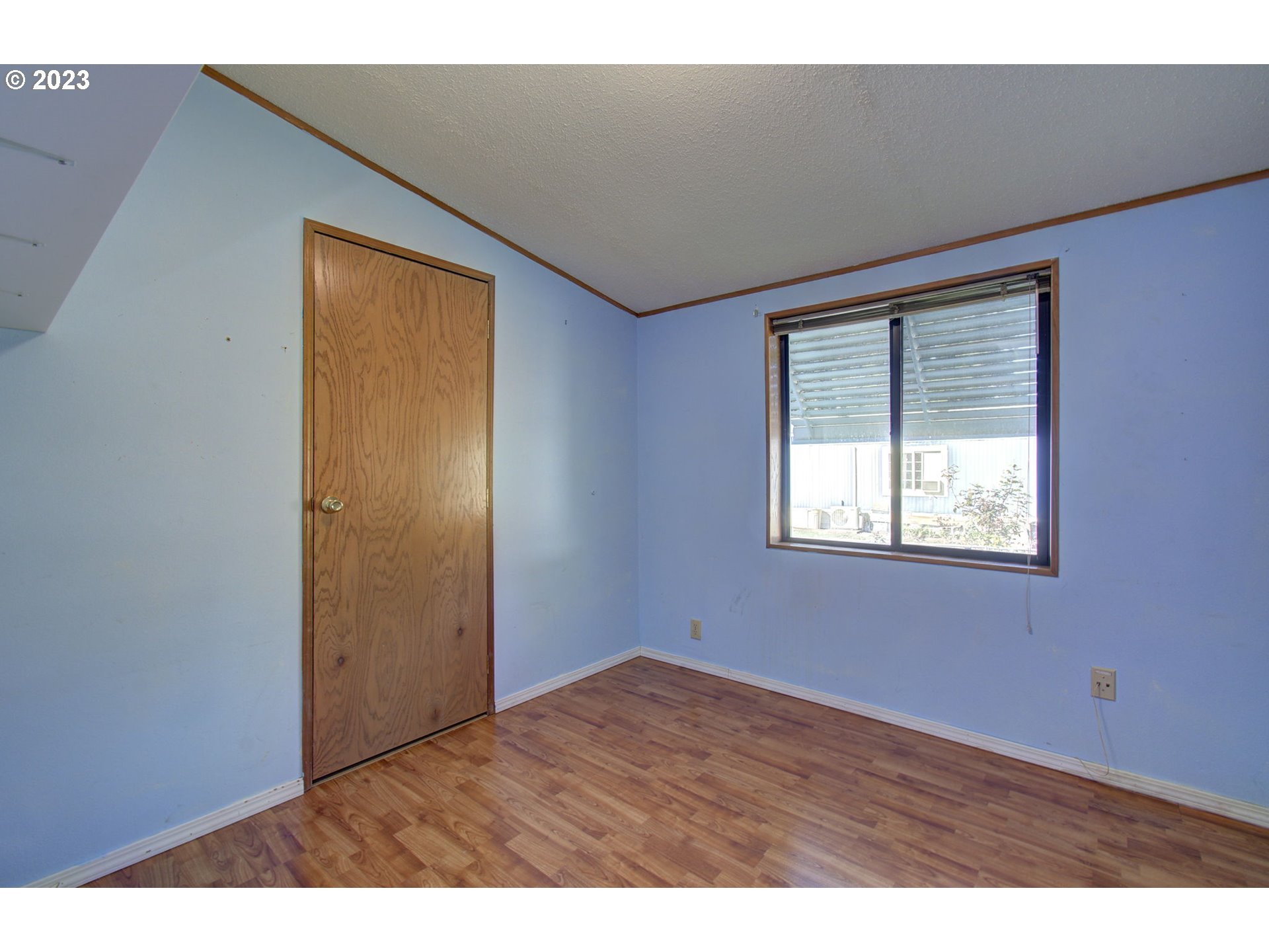15619 Northeast Caples Road Brush Prairie, WA 98606 - Photo 13 of 27 an empty room with wooden floor and windows