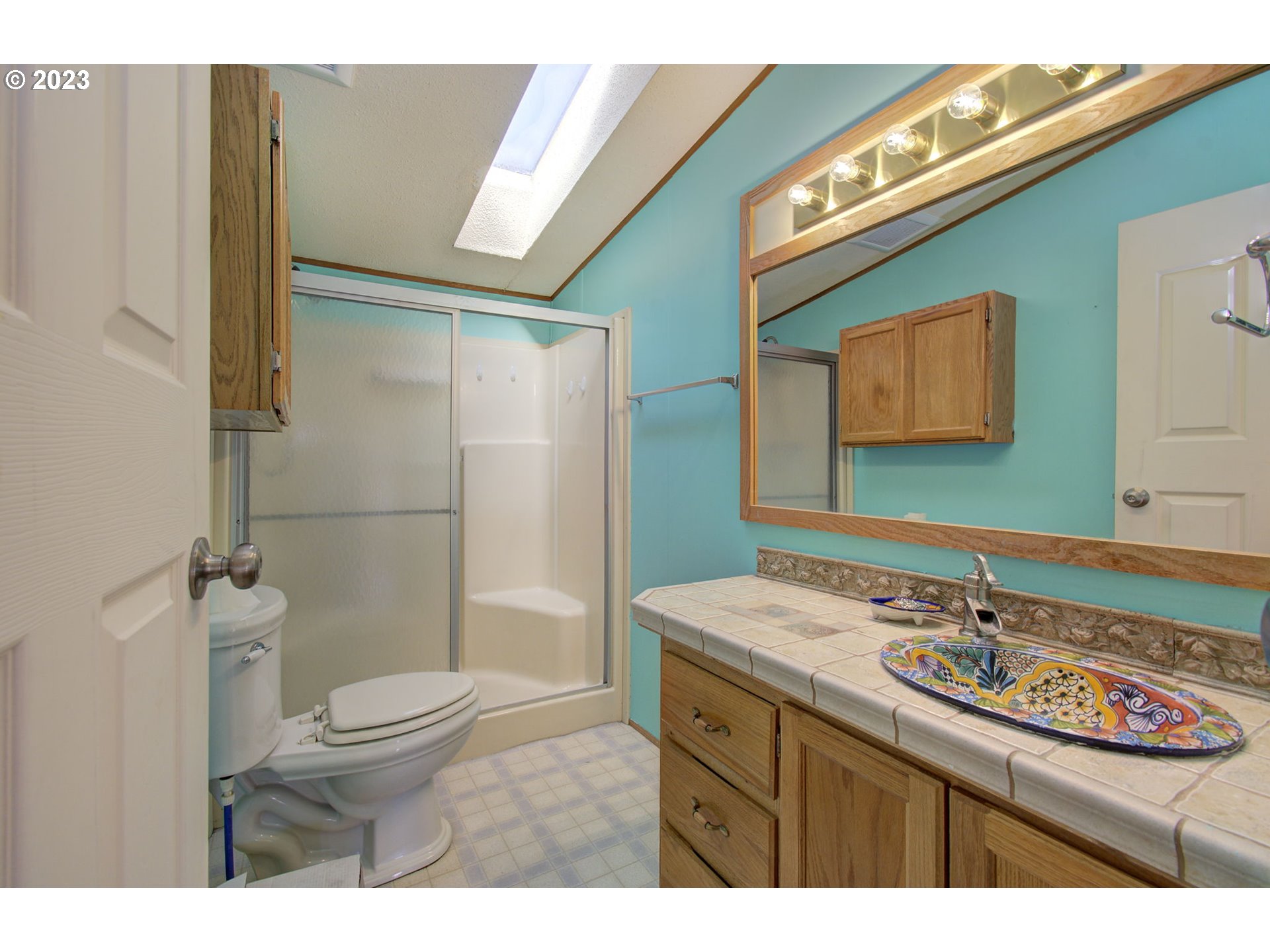 15619 Northeast Caples Road Brush Prairie, WA 98606 - Photo 15 of 27 a bathroom with a sink a toilet and shower