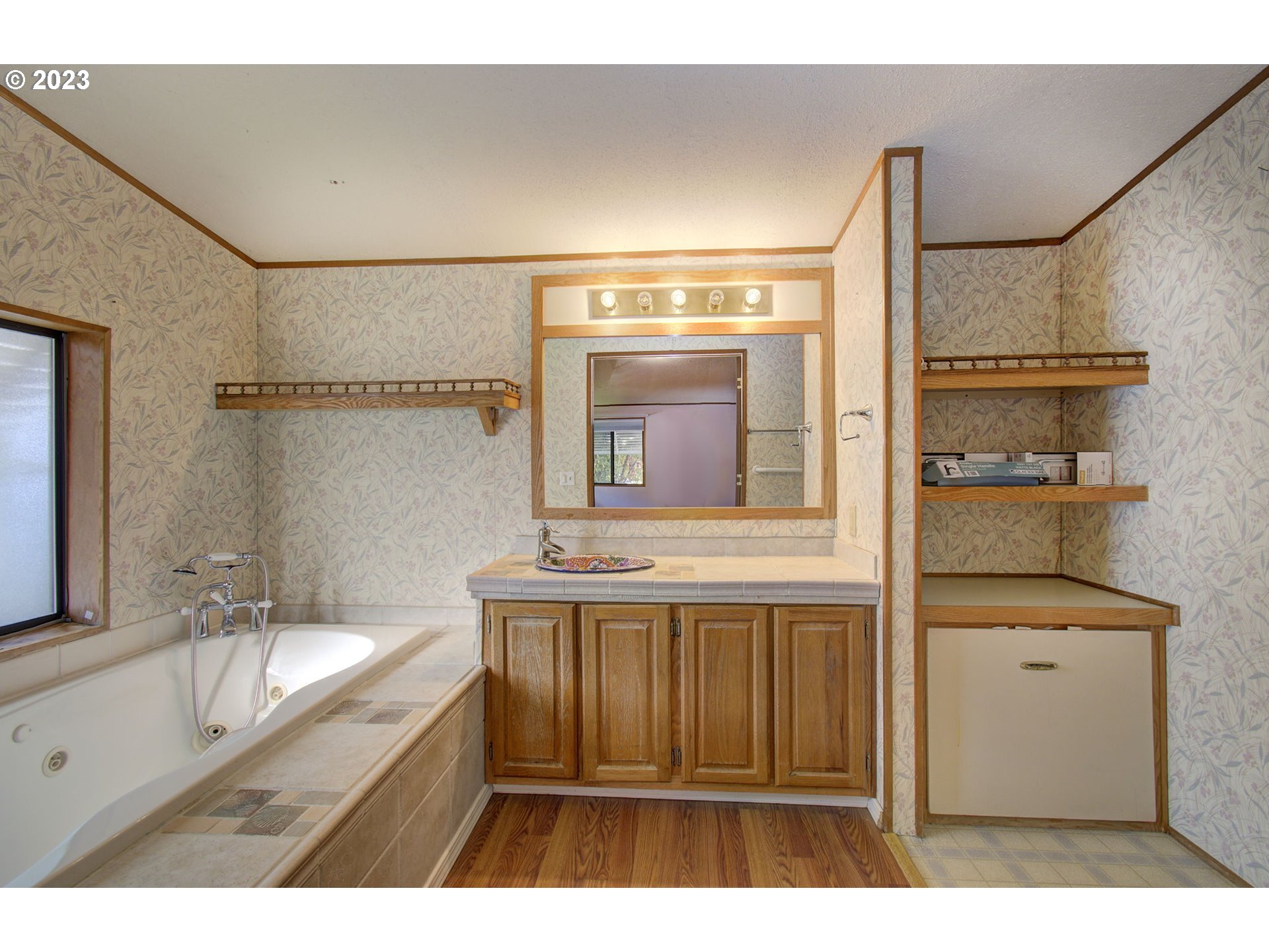 15619 Northeast Caples Road Brush Prairie, WA 98606 - Photo 18 of 27 a bathroom with a sink a mirror and a bathtub