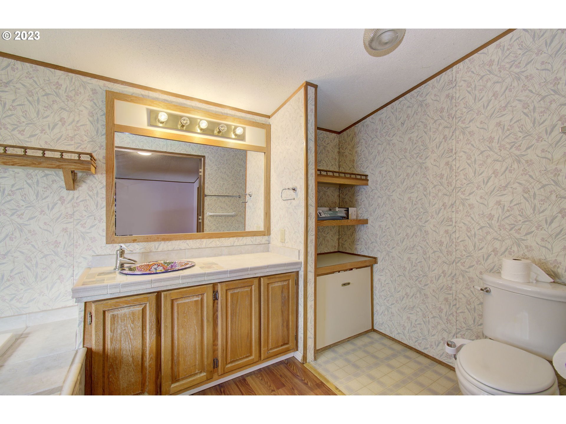 15619 Northeast Caples Road Brush Prairie, WA 98606 - Photo 20 of 27 a bathroom with a toilet a sink and mirror