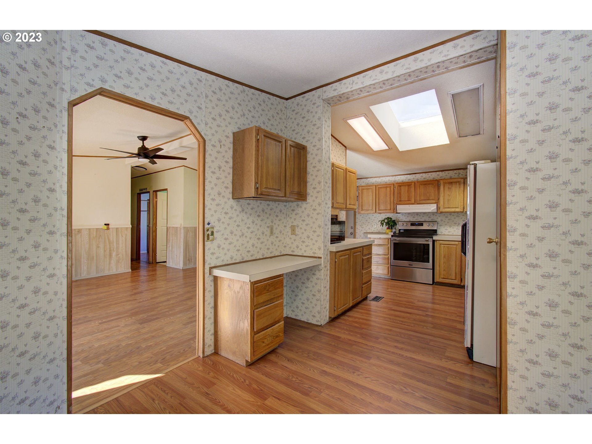 15619 Northeast Caples Road Brush Prairie, WA 98606 - Photo 6 of 27 a view of a kitchen with a sink wooden cabinets and a refrigerator