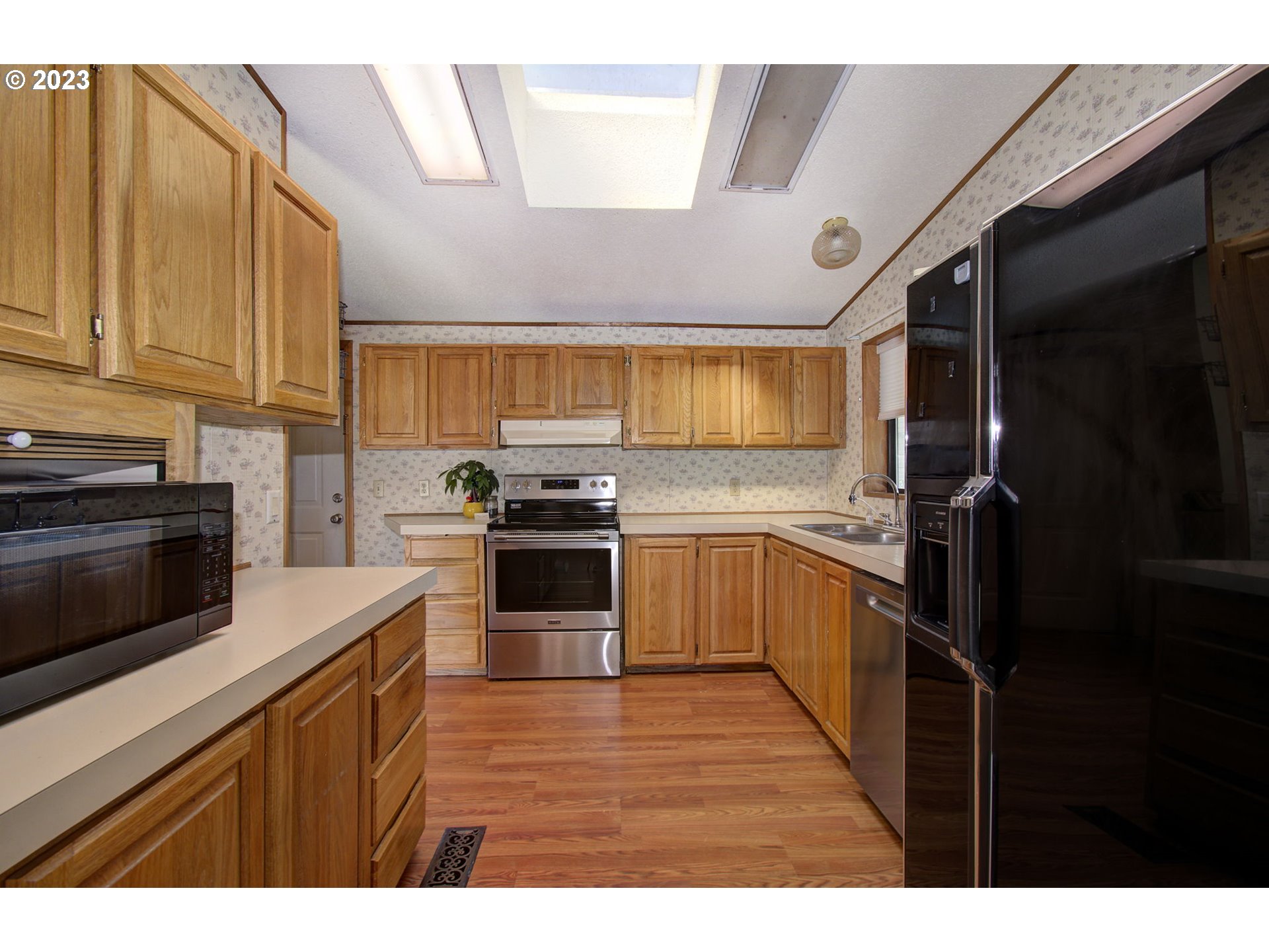 15619 Northeast Caples Road Brush Prairie, WA 98606 - Photo 10 of 27 a kitchen with a sink stainless steel appliances and cabinets