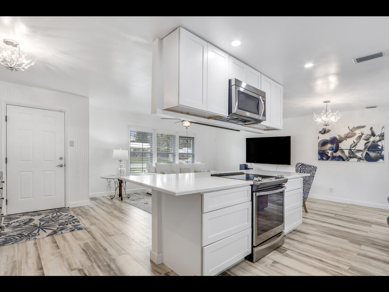 609 Oak Terrace Jupiter, FL 33458 - Photo 11 of 28 a view of kitchen with microwave stove top oven and cabinets